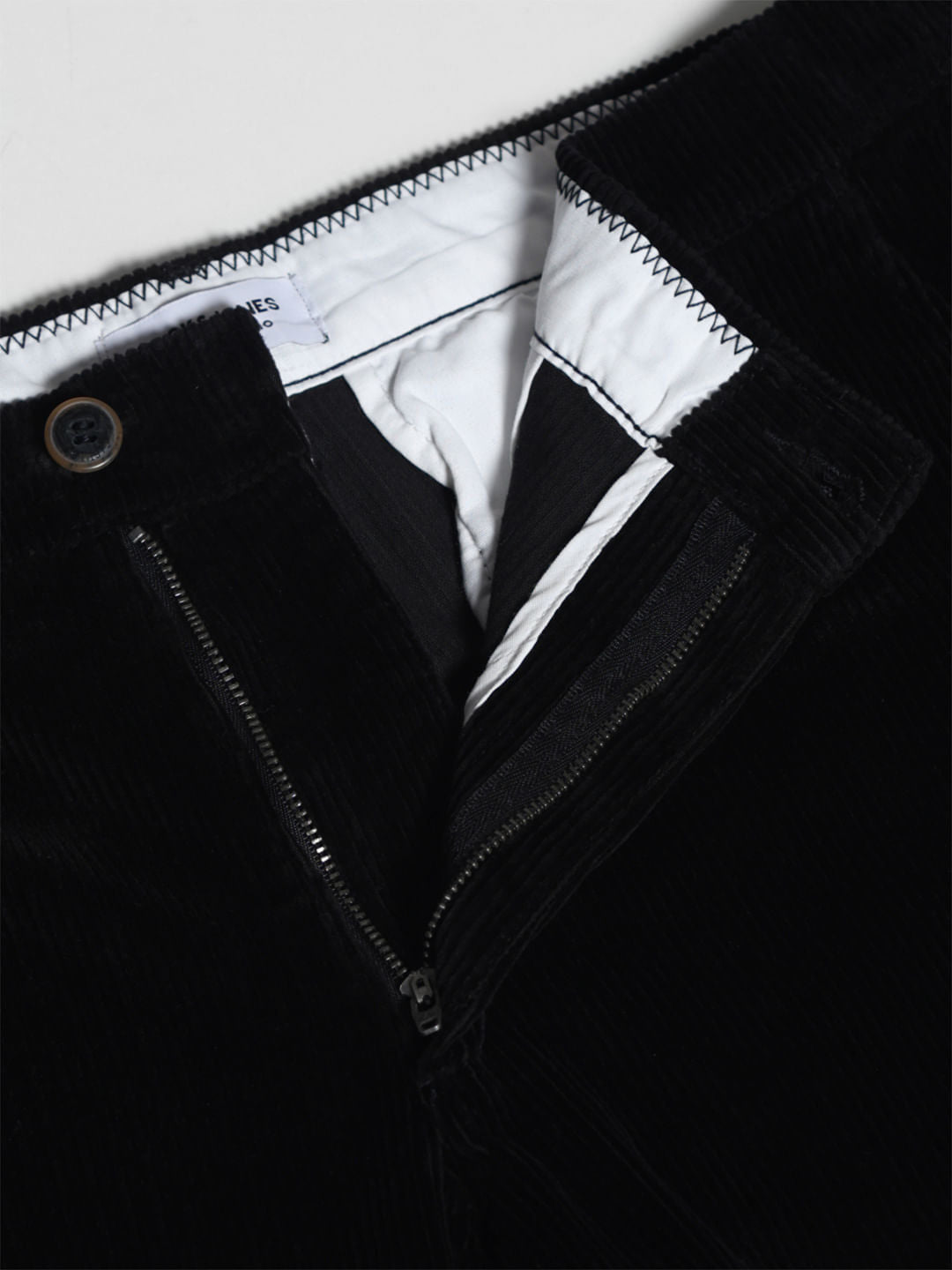 BLACK LOW RISE CORDUROY CHINOS